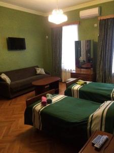 克瓦雷利Guesthouse Raisa的酒店客房,设有两张床和一张沙发