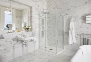 巴斯Bathen House Boutique Hotel的带淋浴和盥洗盆的白色浴室