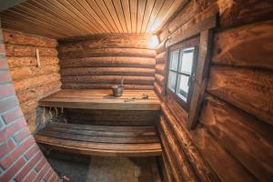 LīvāniPIRTS NAMIŅŠ "Avotiņš"的小木屋内的小房间,配有长凳