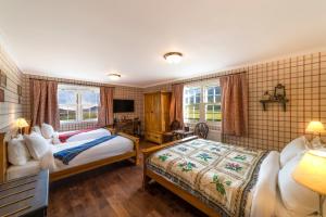 GlenmoristonThe Cluanie Inn的酒店客房设有两张床和电视。