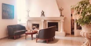 普特布斯拜德翰斯戈尔酒店的客厅配有两把椅子和壁炉