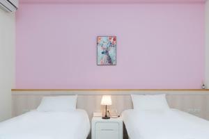 寿丰菓香101民宿fruity101的墙上有两张照片的房间