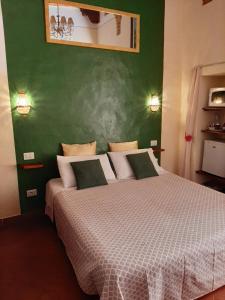 圣吉米纳诺Locazione Turistica Totti的一间卧室设有一张大床和绿色的墙壁