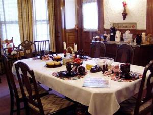 特洛伊奥尔德法官大厦住宿加早餐酒店的一张桌子,上面有白色的桌布,上面有食物