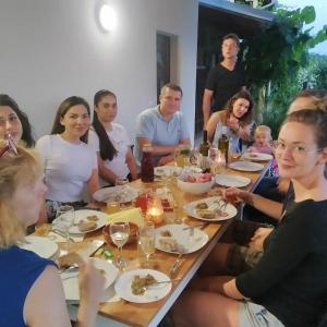 BatočinaHotel Cider&Squash, Grncarska 8, Prnjavor的一群坐在桌子旁吃食物的人