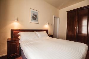 圣赫利尔泽西Villa Nova的一间卧室配有一张带白色床单的大床
