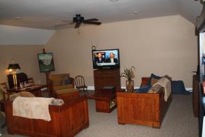 Pilot MountainA Mighty Oak B&B的客厅配有木制家具和平面电视