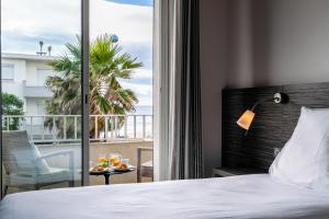 帕拉瓦莱弗洛迪米迪海滨酒店的酒店客房设有一张床和一个阳台。