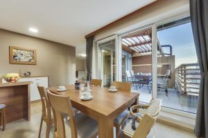 摩拉瓦托普利采J&M Spa Holiday Home Terme Vivat的厨房以及带木桌和椅子的用餐室。