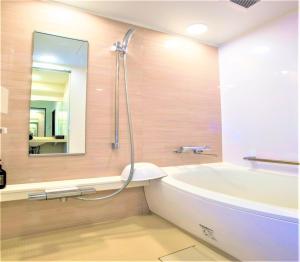 横滨SHIN YOKOHAMA SK HOTEL - Non Smoking - Vacation STAY 86110的带浴缸、水槽和镜子的浴室
