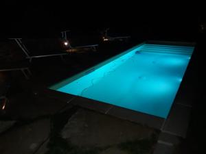 CerbaioloI Poggi di Belvedere的游泳池在晚上点亮