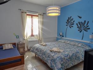 萨萨里I Due Ciuchini Sardinia的一间卧室设有一张床和蓝色的墙壁