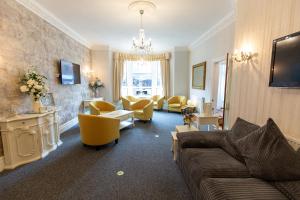 布莱克浦卡尔顿酒店的带沙发和黄色椅子的客厅