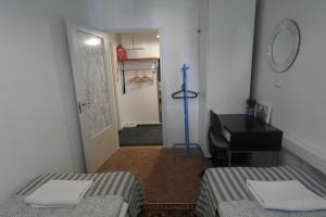 图尔库图尔库城市中心公寓的客房设有两张床、一张桌子和一面镜子。