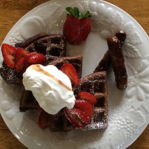 卡南代瓜The Bed and Breakfast at Oliver Phelps的配草莓和奶油的华夫饼