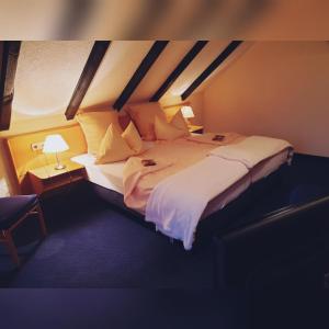 普莱滕贝格Hotel Klinger的卧室配有一张带白色床单和枕头的大床。