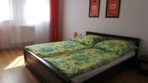 波别罗沃Apartamenty Kornel的一间卧室配有一张带鲜花棉被的床