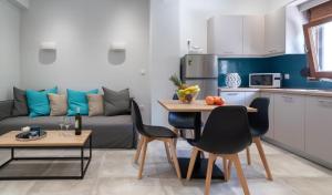 阿尔米罗斯海滩Karavos Apartments Almyros的厨房以及带沙发和桌子的客厅。