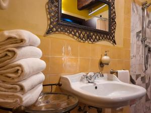佩夏OASI LIGNANA Apartments的浴室配有盥洗盆、镜子和毛巾