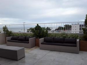 若昂佩索阿哥斯达都阿特兰提可酒店的两张沙发,位于一个海景阳台上,背景是