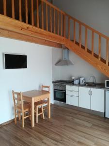 阿尔热祖尔Vila Lira的厨房设有木桌和木楼梯。
