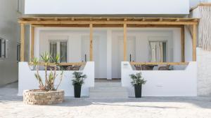 纳克索乔拉Hora Seaside Suites的白色的房子,配有两张桌子和椅子