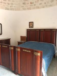 阿尔贝罗贝洛Trulli della Masseria Staffone的一张带木柜的床