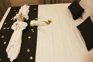 萨比奥特Hotel Rural Molino del Albaicín的一张带白色连衣裙和黑色领结的床