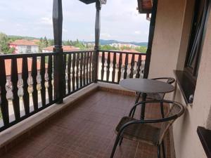 贝尔科维察德梅特拉家庭旅馆的阳台配有桌子和两把椅子,设有窗户。