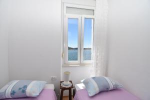 希贝尼克Apartmani Rina的一间卧室设有两张床和窗户。