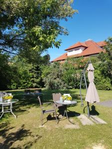 克桑滕Xotel的花园配有桌椅和遮阳伞。