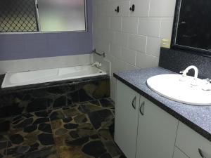 米申海滩Royal Palm Cottage, Entire two bedroom 2 bathroom house with Pool的浴室配有盥洗盆和浴缸。