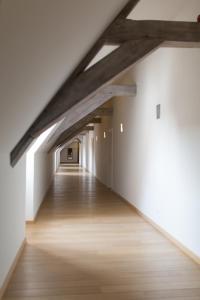 根特Het Rustpunt的阁楼走廊铺有木地板,拥有白色的墙壁