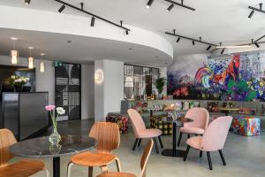 圣加仑Sorell Hotel City Weissenstein - Boutique Hotel的配有桌椅和绘画的房间