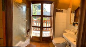 Los Espejos de la ReinaCasa Rural La Costurera的一间带卫生间、水槽和窗户的浴室