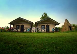 格丁尼亚Domki letniskowe Babie Doły的草地上的两所小房子
