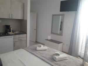 巴什卡沃达Villa Rosso的白色的厨房,床上配有2条毛巾