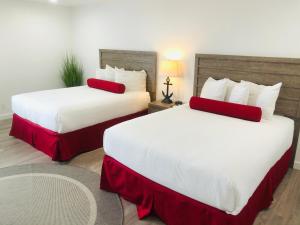 莫罗贝莫罗湾兰德恩酒店的酒店客房 - 带两张带红色枕头的床