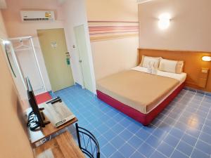 普吉镇太平洋酒店的一间设有床铺和电视的房间