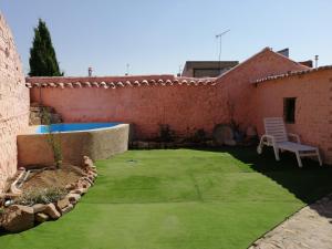Corral de CalatravaCasa Rural La Alfarera的一个带游泳池和椅子的小院子