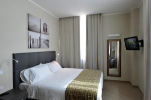 热那亚希艾曲西商务住宅酒店的酒店客房,配有床和镜子