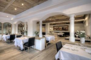 科瓦拉因巴迪亚拉塔布拉酒店的餐厅设有白色的桌椅和柱子