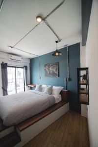 尖竹汶谦婵旅舍的一间卧室配有一张带蓝色墙壁的大床