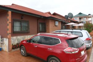 SenchiSanta Monica Home Lodge的停在房子前面的红色汽车