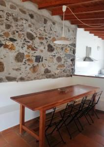 埃尔米瓜卡萨斯乡间赫咪咕呀酒店的石墙客房内的木桌