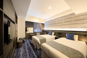 Quintessa Hotel Sapporo Susukino客房内的一张或多张床位