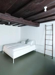 林茨CHARMANTES APARTMENT im Herzen von Linz的白色的房间,配有床和梯子