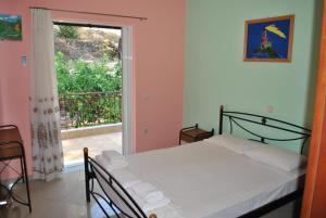 苏卡雷斯Monika Lefkada的一间卧室设有一张床和一个阳台的窗户。