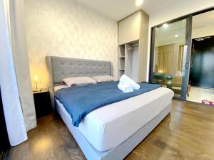 努沙再也Almas Suites Puteri Harbour的一间卧室配有一张带蓝色毯子的大床