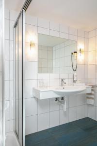 韦斯巴德Hotel Alpenblick的一间带水槽和镜子的浴室
